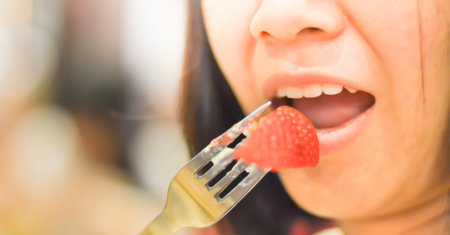 Woman eating a strawberry berries and dessert