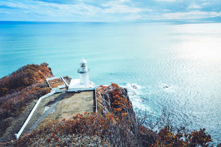 Lighthouse and ocean with blue sky at cape Chikyu Hokkaido Japanの写真素材