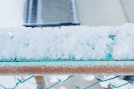 Snow on metal net at park for background