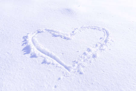 Handwriting heart shaped on snow for textureの写真素材