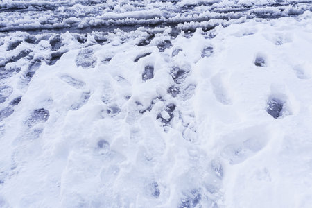 Footprint and hands on snow for texture background