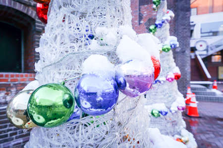 ball and light bulb on christmas treeの写真素材