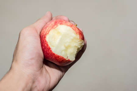 Apple is bitten in the hand.の写真素材