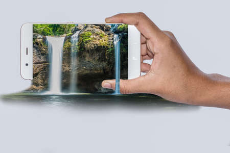 Pop Up Waterfall hand holding mobile phoneの写真素材
