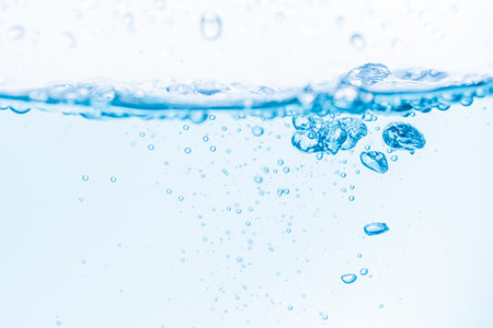 Surface of the blue water waves splash on a white background