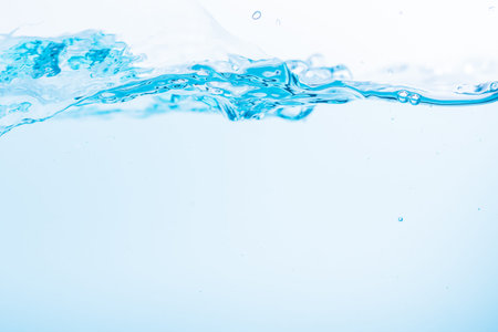 Surface of the blue water waves splash on a white background