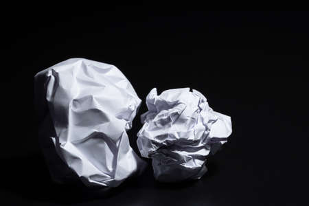 Crumpled paper ball on black backgroundの写真素材