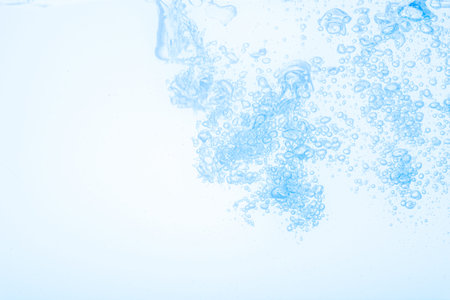 Bubbles in blue water against a white background