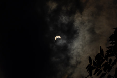 Solar Eclipse with Clouds in the Sky