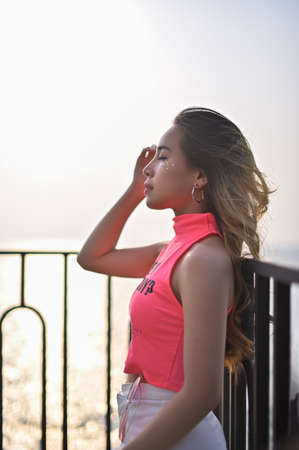 Portrait of a beautiful woman, a pink shirt, a white skirt, a dress on Valentine's Dayの写真素材