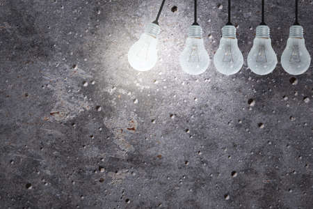 Light Bulbs Concept gray cement backgroundの写真素材