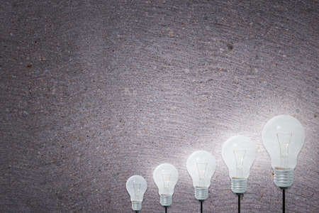 Light Bulbs Concept gray cement backgroundの写真素材