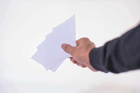 The business man is holding the document on the white backgroundの写真素材