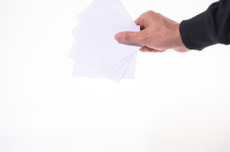 The business man is holding the document on the white backgroundの写真素材