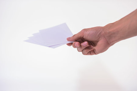 The business man is holding the document on the white backgroundの写真素材