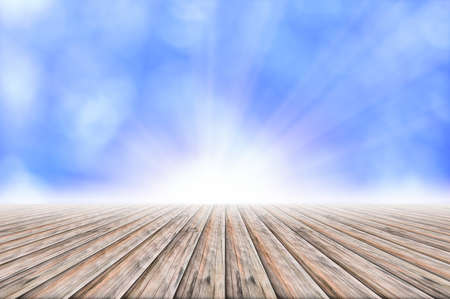 Wooden floor, light blue bokeh background with light beamの写真素材