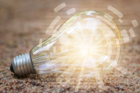 Digital light bulb / illuminated in the sandの写真素材
