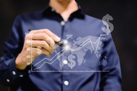 Business people display graphs for trading money around the worldの写真素材