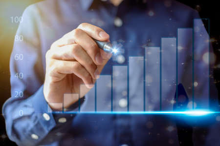 Business people display graphs for trading money around the worldの写真素材