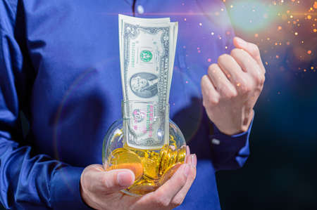 The idea of businessmen holding money, making profits, saving money.の写真素材