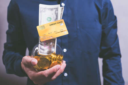 The idea of businessmen holding money, making profits, saving money.の写真素材