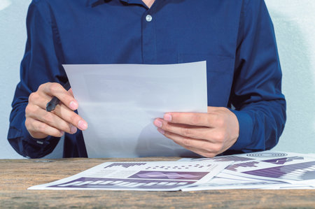 The business man checks the accounts and documents on the table