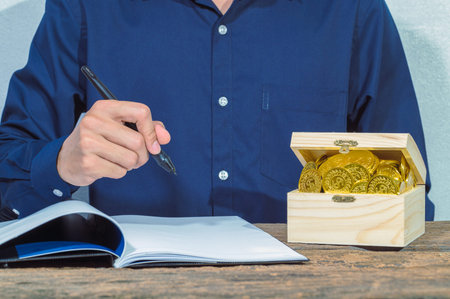 Businessman checks accounts documents and money saving ideas on the table