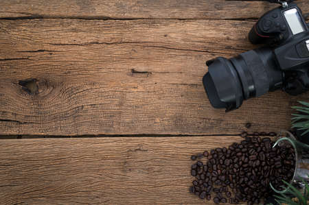 The background has a camera, coffee beans are placed on the table, top view.の写真素材