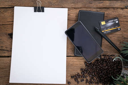 Documents, smartphones, credit cards are placed on the top view table.の写真素材