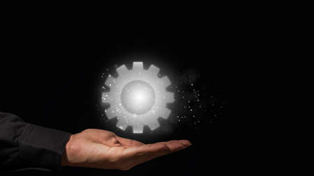 Hands support gear-shaped graphics instead of working symbols.の写真素材