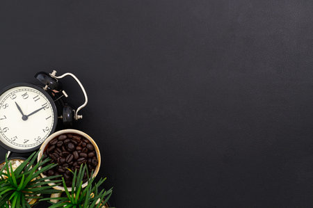 mug coffee beans and a clock on the desk, top view