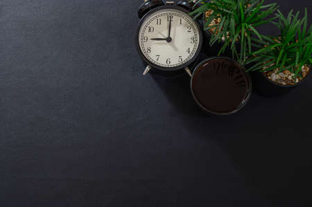 mug coffee and a clock on the desk top viewの写真素材