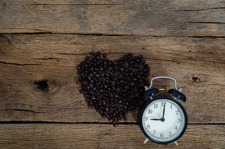 Clock and coffee beans Sitting on the desk top viewの写真素材