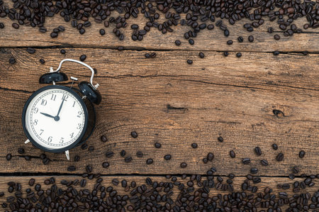 clock and coffee beans on the desk top view