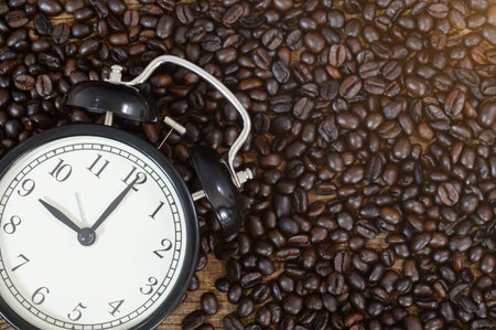 Clock and coffee beans Sitting on the desk top view