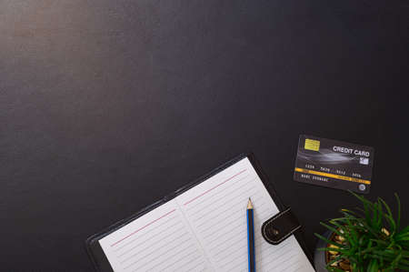 Record book Pencil and credit card At the desk, top viewの写真素材