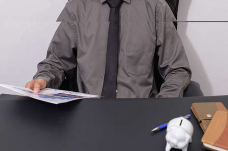 Business people check documents at their desksの写真素材