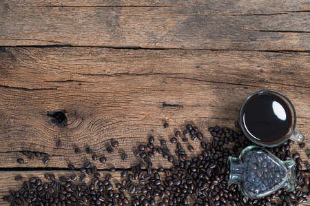 Coffee mugs and coffee beans are on the deskの写真素材