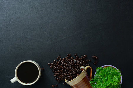 Coffee mugs and coffee beans, trees on the desk, top view