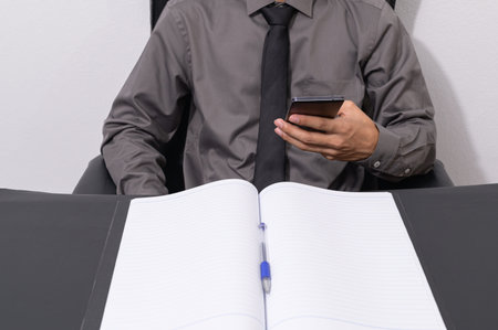 Business people use smartphones at their desks