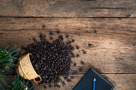 Notebook and coffee beans are placed on wooden table