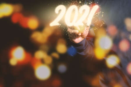 Human hand and the beginning of New year 2021の写真素材
