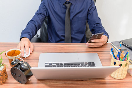 Business people work through notebook computers At the desk in the room