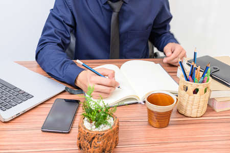 businessman examines the documents at the desk in the roomの写真素材