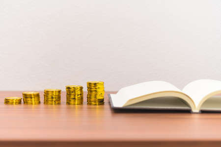 Book and coin pile ideas Business growth At the deskの写真素材