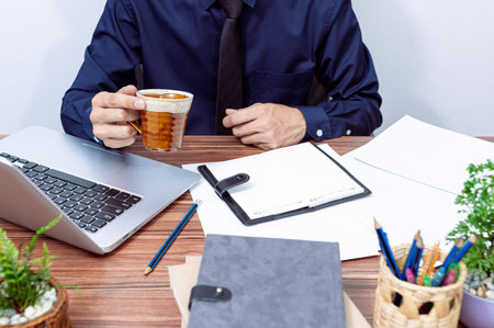 business man drinking coffee at his desk