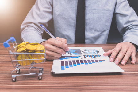 Businessman examining business financial growth graph documentの写真素材