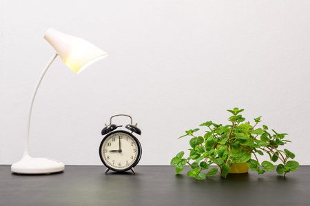Clock and lamp On the desk at the office