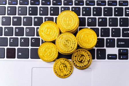 investing and growing a pile of coins placed on the computerの写真素材