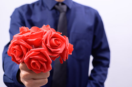 Men hold a bouquet of roses on valentine's dayの写真素材